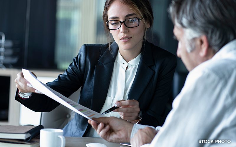 An attorney going over legal paperwork with her client.